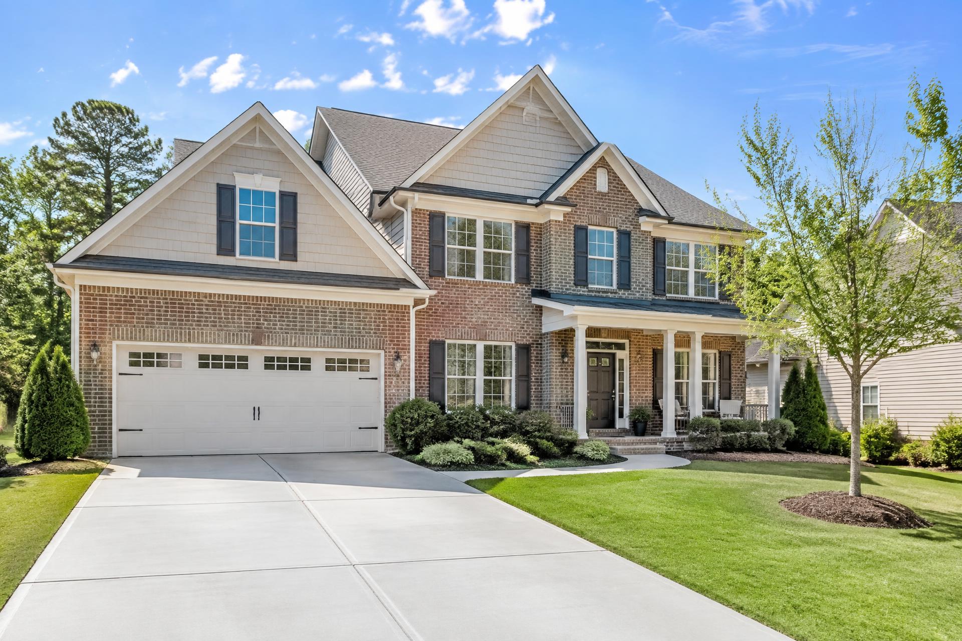 Clean brick home exterior with a spotless driveway at dusk in North Georgia